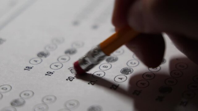 closeup incorrect answer easing the filled in multiple choice answer and changing to to another choice