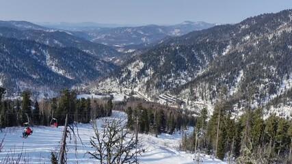 MOUNT KOKUYA, ALTAI, RUSSIA -  09 MARCH 2024: Mount Kokuya is an ideal location for winter sports. 
Views of the ski resort Teletski. Ski resort is located near Lake Teletskoye.
