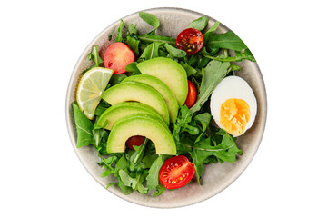 Avocado salad arugula, egg, tomato, mixed greens, vegetables dish fresh delicious gourmet food background tabletop rustic food top view copy space keto and paleo diet vegetarian food