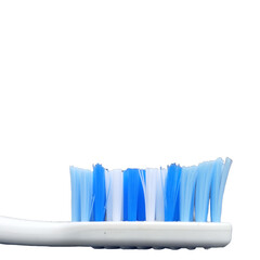 Close-up of a toothbrush head showing bristles in shades of blue and white, dental hygiene