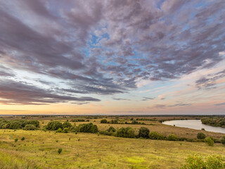 Fototapeta premium Large field with a river running through it