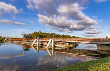 Bridge over a body of water with a cloudy sky in the background