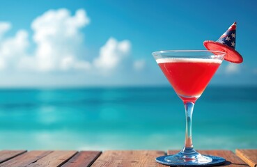 Patriotic cocktail for US Independence Day on tropical beach vacation. Red drink in martini glass with American flag decor. Festive holiday beverage on wood pier overlooks beautiful turquoise ocean