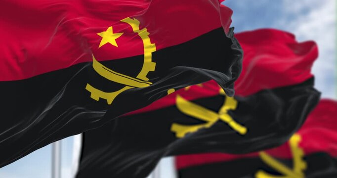 Close-up of Angola national flags waving in the wind on a clear day