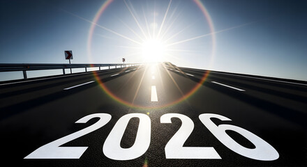 The concept of progress unfolds on an asphalt road leading toward a bright sunburst in the sky with the year 2026 painted on the surface symbolizing a journey towards a future horizon filled with