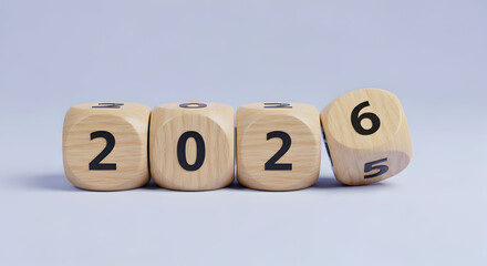 Wooden blocks with numbers display an arrangement indicating the transition from the year 2025 to 2026 with a simple background, forecasting a prosperous future and the new year period with hope for