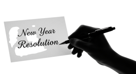 Hand writing new year resolution on a piece of paper