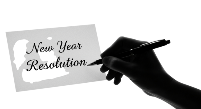Hand writing new year resolution on a piece of paper