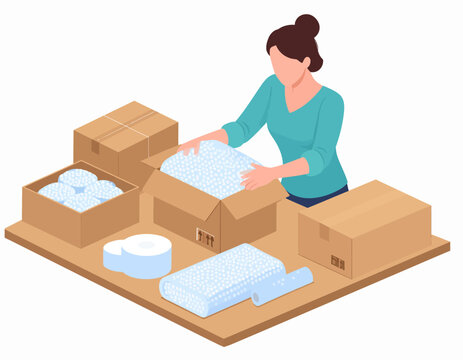 Woman packing items into a cardboard box with bubble wrap, surrounded by other boxes and packing supplies on a wooden surface.