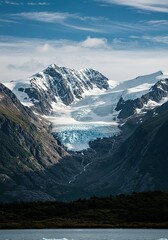 Majestic glacier clinging to a towering mountain range under a vast sky, showcasing ancient ice formations and rugged wilderness ,snow ,high altitude ,frozen