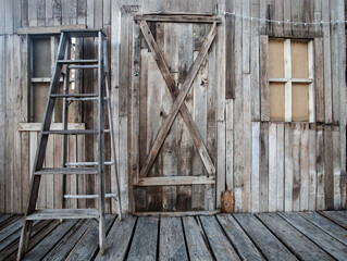 Abandoned Building with matching ladder leaning on front porch