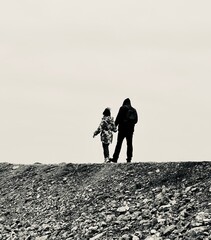 a family walks along the pier