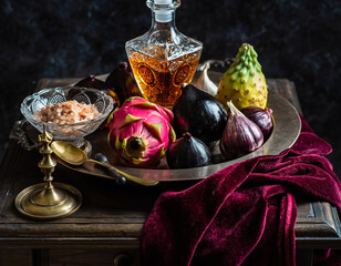 Opulent Vintage Still Life with Dragon Fruit, Exotic Produce, and Crystal Decanter on Velvet Drape