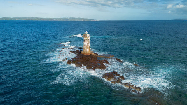Mangiabarche lighthouse on rocky coast near Calasetta Sardinia - Powered by Adobe