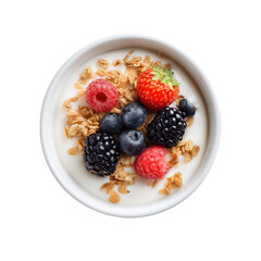 A top-down view of a white bowl filled with creamy yogurt topped with granola, fresh raspberries, blueberries, and blackberries. 