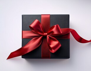 a black square shaped gift box with red ribbon on an isolated background
