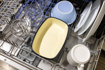 Clean dishes inside an open dishwasher drawer