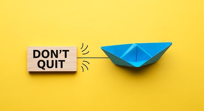 A blue paper boat is pulled by a sign that says dont quit on a yellow background