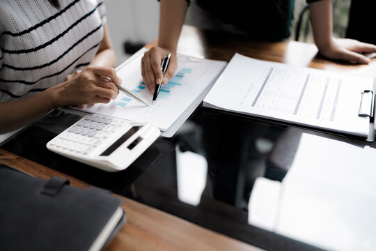 Business administrator reviewing financial reports and marketing analysis for company sales growth and strategy development