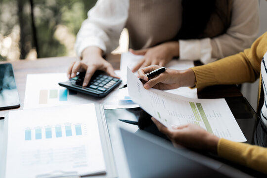 Business administrator reviewing financial reports and marketing analysis for company sales growth and strategy development