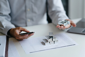Businessman reviews silver market charts for investment opportunities