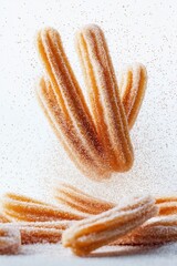 churros flying with cinnamon sugar dust, isolated on white background