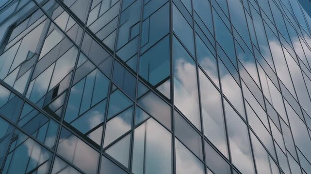 Moving clouds reflection on modern glass building