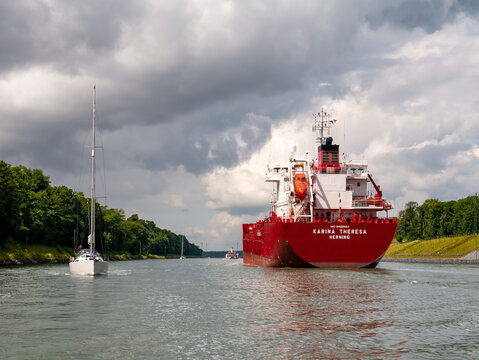 Oil and chemical tanker Karina Theresa and sailboats on Kiel Canal, Nord-Ostsee-Kanal, in Schleswig-Holstein, Germany