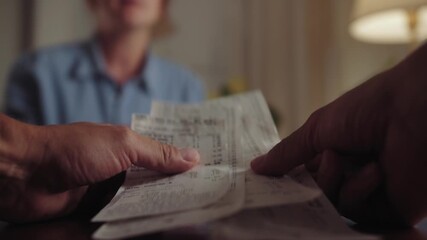 Depressed young couple arguing while checking their financial debt. Family frustrated with paperwork and bills, worried about the financial problems. High quality 4k footage - Powered by Adobe