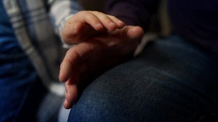 Little boy holding grandpa's hand, trusting family relationship, love and care