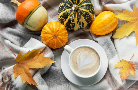 Warm coffee with latte art and autumn pumpkins - Powered by Adobe
