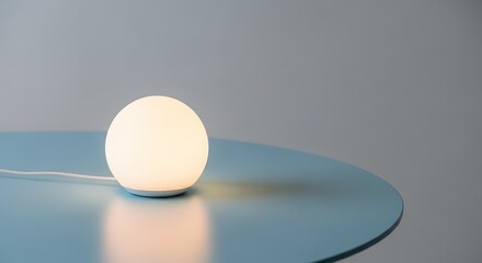 Minimalist egg shaped lamp glowing on a blue table