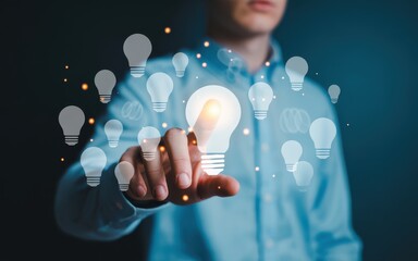 Businessman touching a glowing lightbulb icon on a virtual interface, symbolizing a new creative idea and innovation