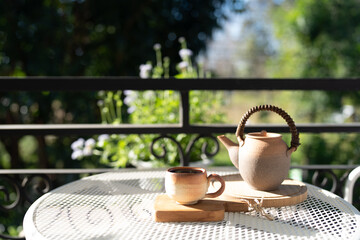earthenware Tea set on balcony outdoor in winter under strong sunlight