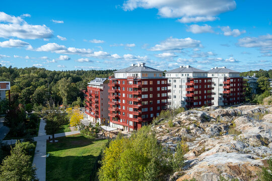 Urban garden sustainability greenery architecture housing Hjorthagen Stockholm Sweden calm atmosphere showcased through a serene green corridor enhancing modern residential identity