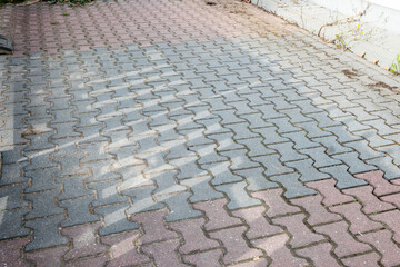 City road sidewalk repair with much pavement tiles black and red colour.