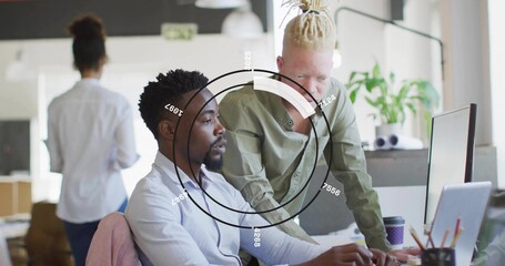 Collaborating coworkers wearing button-downs pointing at monitor in open office, with HUD overlay