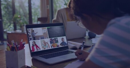 Writing girl wearing striped shirt joining online class at home using laptop pencil cup, copy space