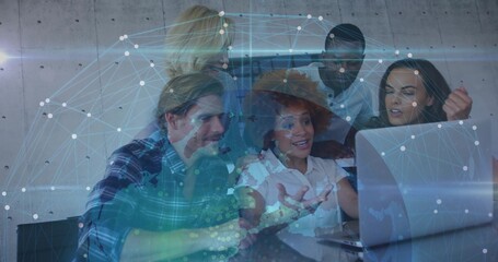 Collaborating team reviewing laptop in office, woman in wide hat white blouse, network overlay