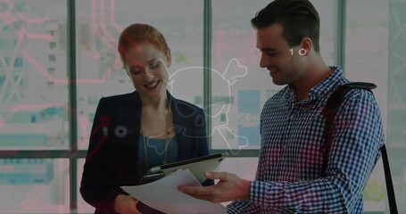 Reviewing coworkers in business wear, examining tablet and papers in modern office with overlay