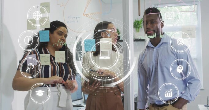 Adjusting three-person team in business wear, moving post-its and drawing on glass wall, HUD icons