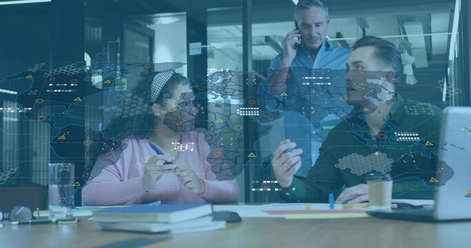 Discussing three colleagues in casual reviewing papers at office with map overlay and smartphone