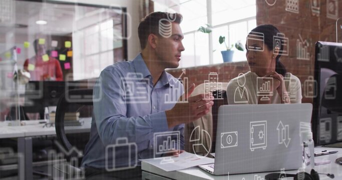 Discussing two coworkers in business attire at office with laptop and glass partition icons