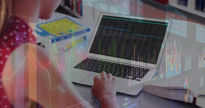 Typing female teen working on laptop at desk in study, red polka-dot top, papers, charts overlay