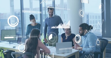 Presenting seated woman in business-casual leading data meeting in office with laptop and charts