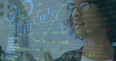 Viewing man with glasses and dark blazer studying transparent market display at office, copy space