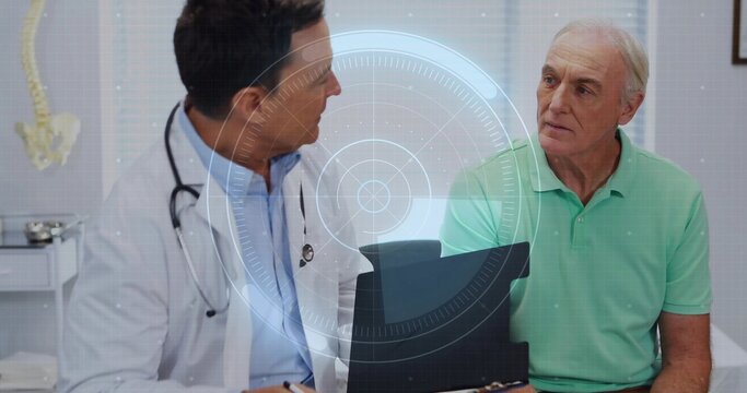 Explaining physician in lab coat, stethoscope viewing tablet with patient in mint polo in clinic - Powered by Adobe