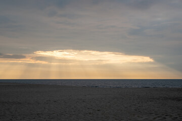Sea, sky, sand, boat on the beach. Alone by the sea at sunset.