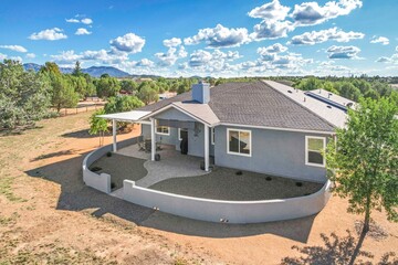 A charming blue house featuring white shutters adorning the windows