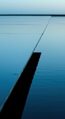 Oblique view showcasing the sharp angle where calm water meets a submerged planar surface, highlighting reflections and geometric clarity ,clear ,ripple ,texture